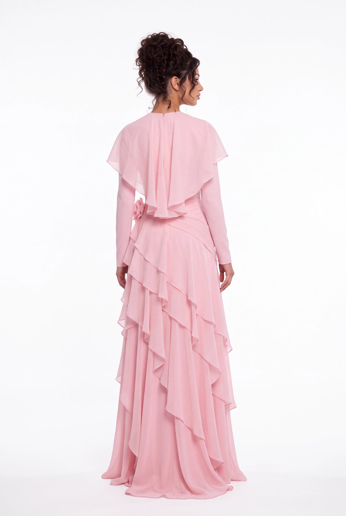 Back view of the Athera blush pink chiffon gown showing the short cape and cascading ruffle tiers