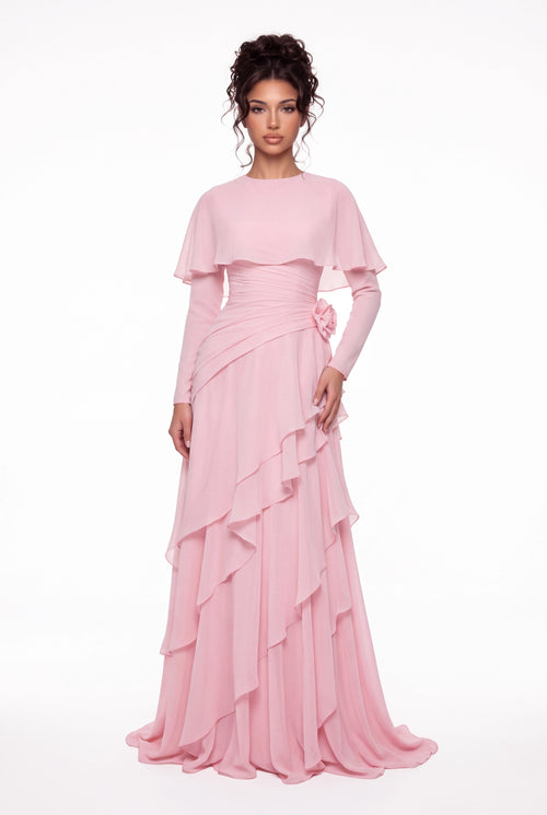 Model wearing the Athera blush pink chiffon cape gown with long sleeves, full-length front view