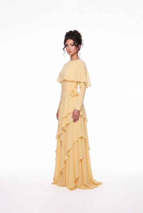 Three-quarter view of the Athera butterfly yellow chiffon gown with asymmetric ruffle skirt