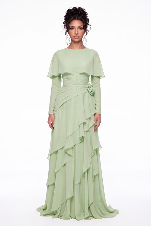 Model wearing the Athera sage green chiffon cape gown with long sleeves, full-length front view