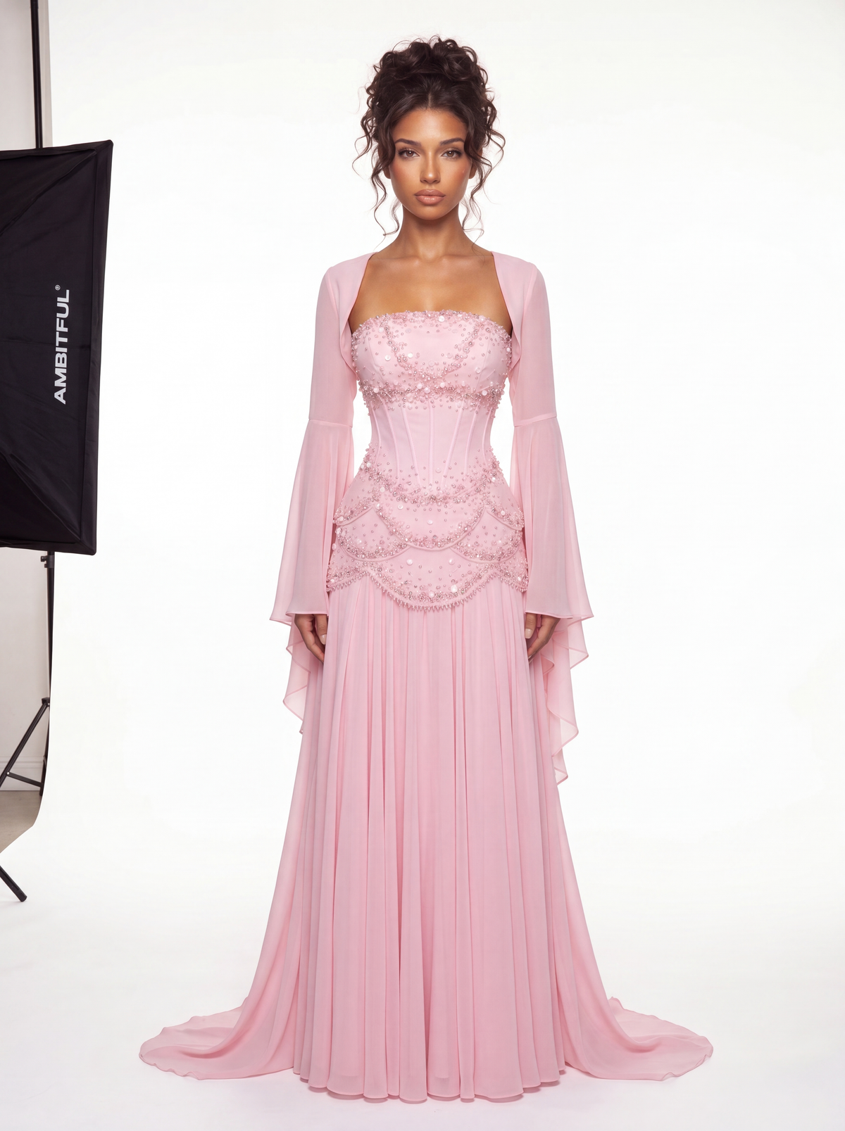 Model wearing the Azura baby pink hand-beaded corset gown with detachable bell sleeves, full-length front view