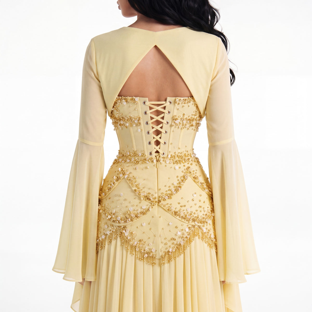 Back of the Azura buttercup yellow gown showing the bell sleeves and ribbon lace-up corset