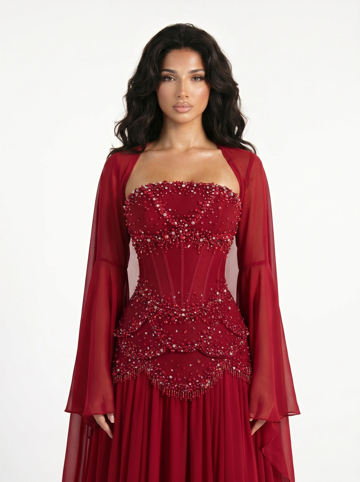 Model wearing the Azura crimson red hand-beaded corset gown with detachable bell sleeves, front view