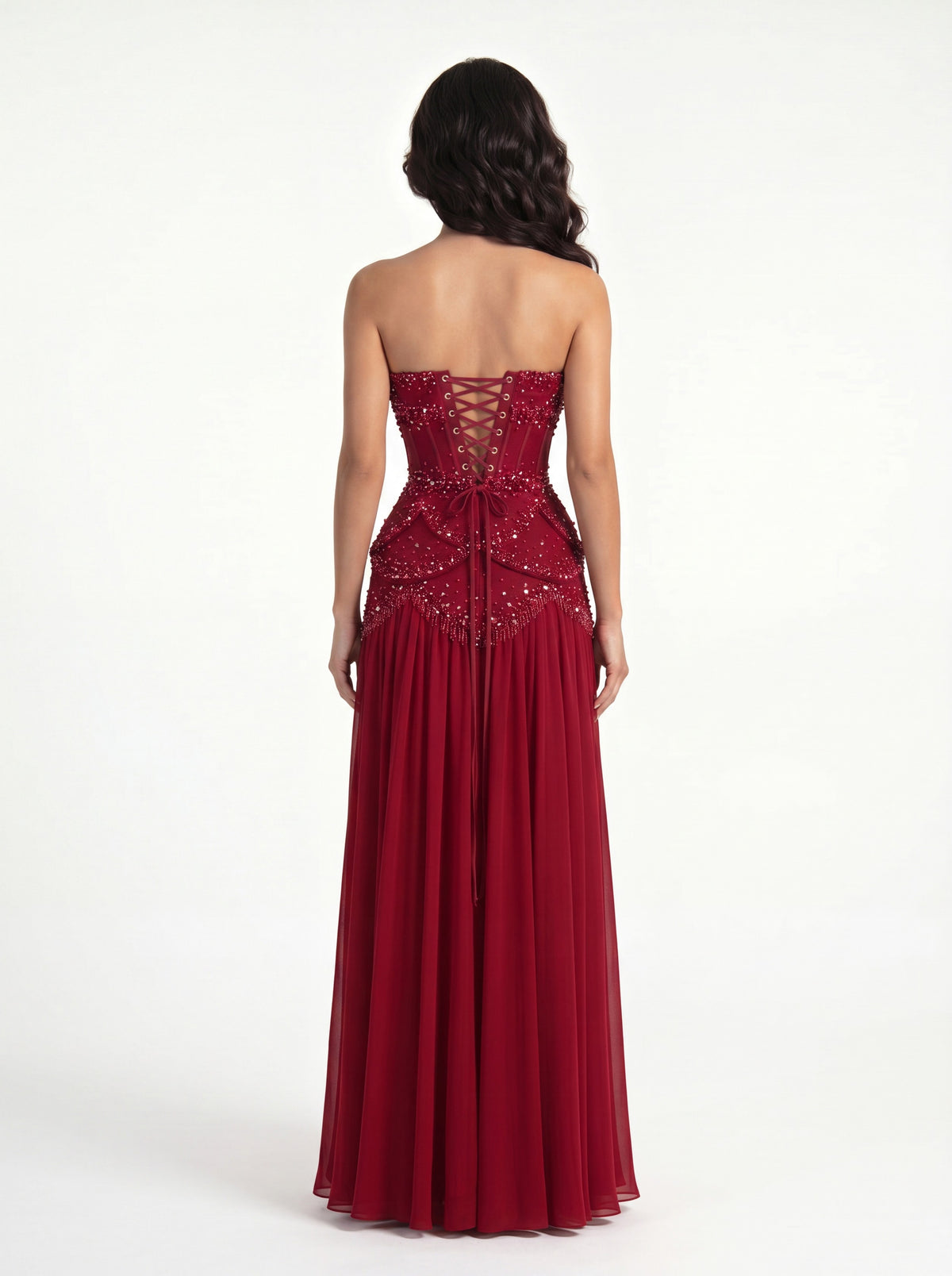 Back view of the Azura crimson red gown worn strapless, showing the ribbon lace-up corset